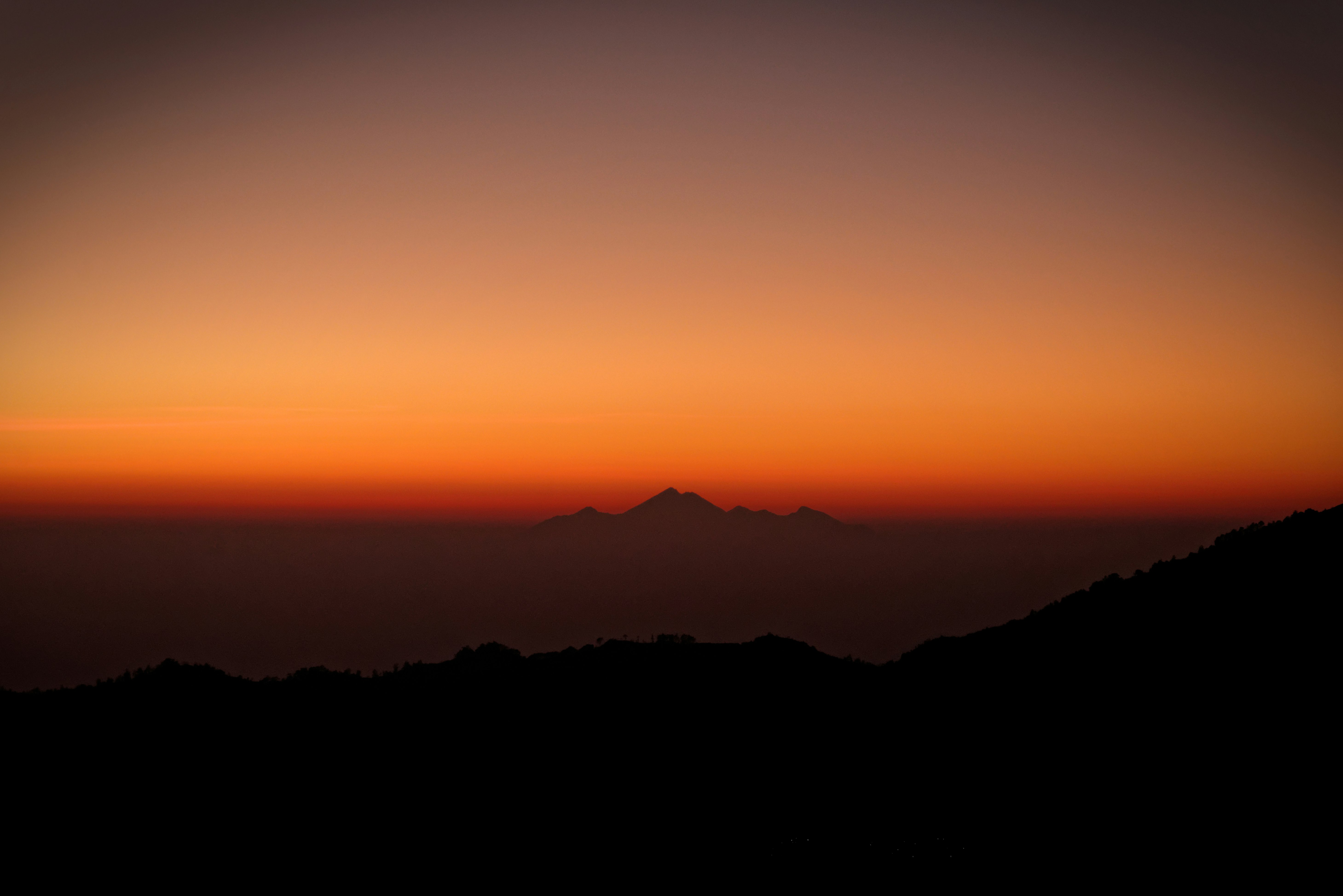 silhouette photography of mountains during sunset